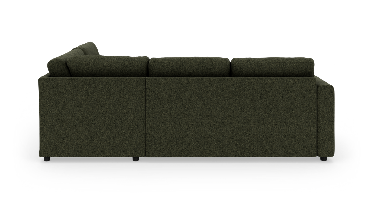 Mørkegrøn modulsofa med ryghynder set fra siden/bagsiden, frilagt på hvid studiebaggrund.