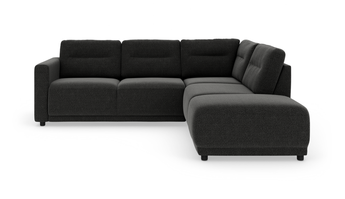 Mørkegrå L-formet modulsofa med chaiselong til højre, fotograferet i studie fra en let frontvinkel.