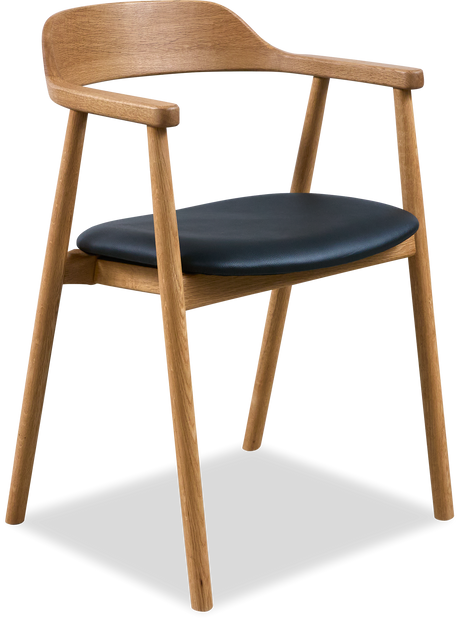 Lys stue med grøn sofa, puder og plaid, rundt sofabord i træ, gulvlampe, vægbilleder, vase med pampasgræs, tæppe og neutrale nuancer.