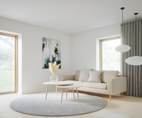 Lyst skandinavisk stue med beige sofa, runde sofaborde, gråt rundt tæppe, pampas i glasvase, abstrakt vægkunst og rispapirspendler ved store vinduer.