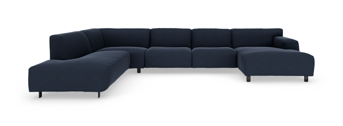 Mørkeblå modulsofa i U‑form med to chaiselonger, fritstående mod hvid baggrund.