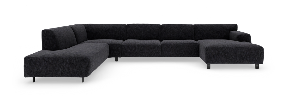 Mørkegrå L‑formet modulsofa med chaiselong, fritstående på hvid baggrund.