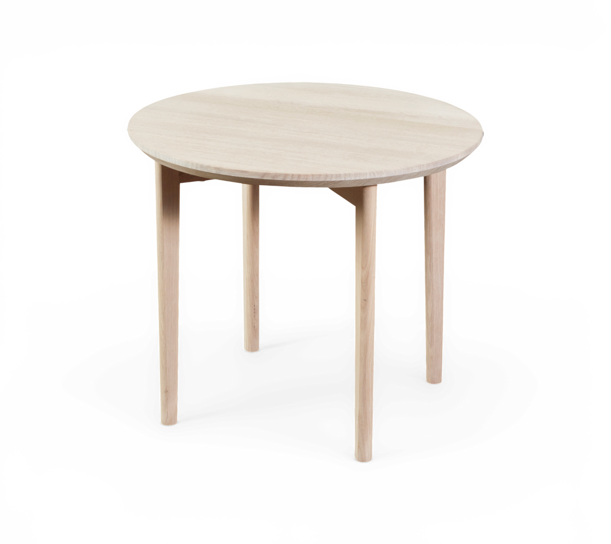 Rundt bord i lyst træ med fire ben og minimalistisk design.