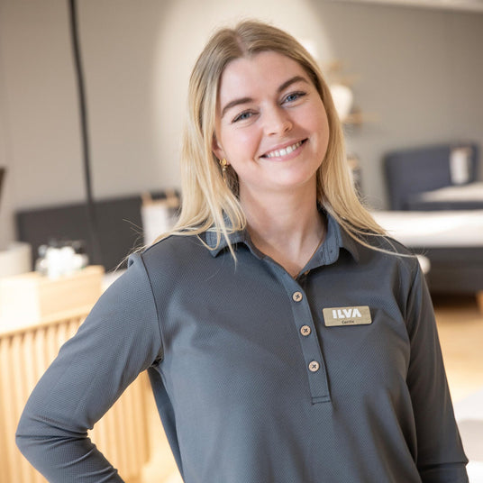 Butiksmedarbejder med ILVA-navneskilt i møbelbutikkens showroom.