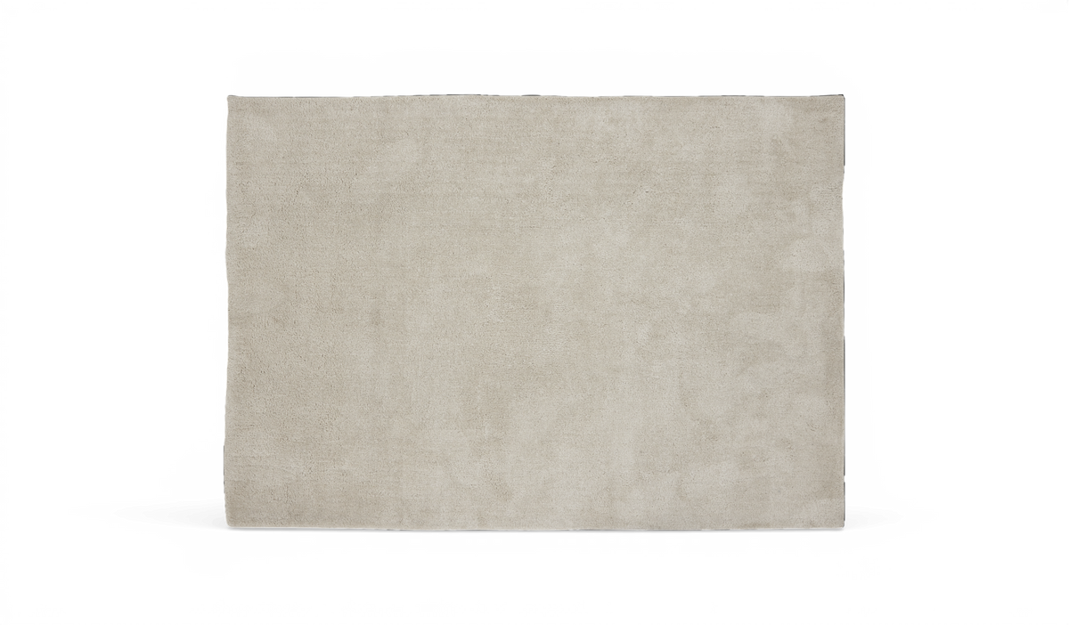 Beige rektangulært tæppe med kort luv på hvid baggrund.