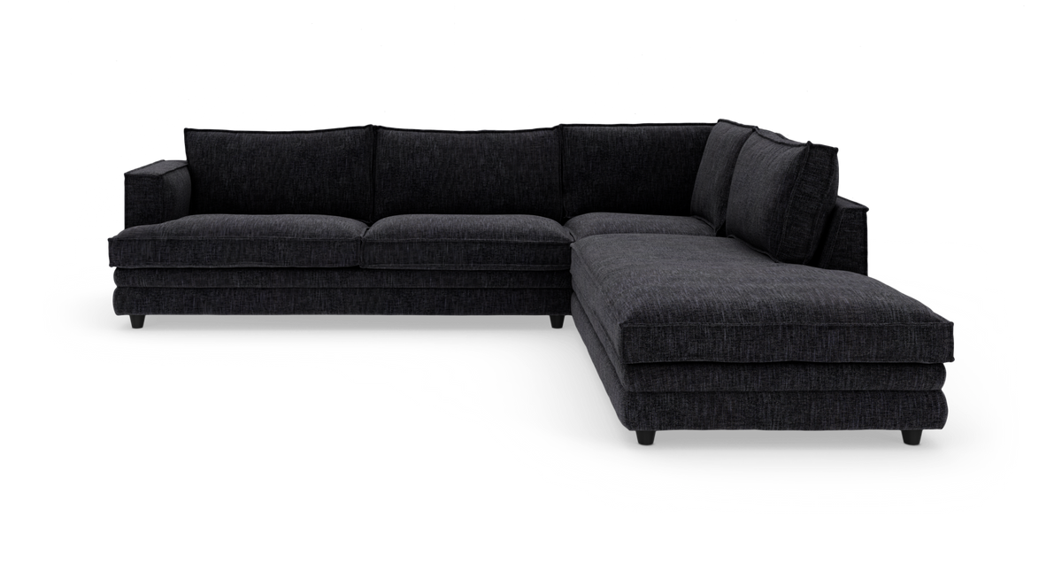 Mørkegrå hjørnesofa med chaiselong til højre, frilagt på hvid baggrund.