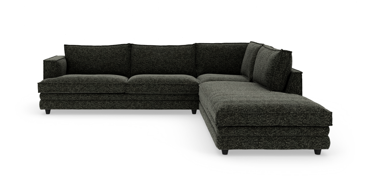 Mørkegrå L-formet modulsofa med chaiselong til højre, fotograferet i studie.