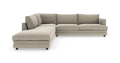 Beige L-formet modulsofa med venstrevendt chaiselong, tykke sædehynder og løse ryghynder på sorte ben.