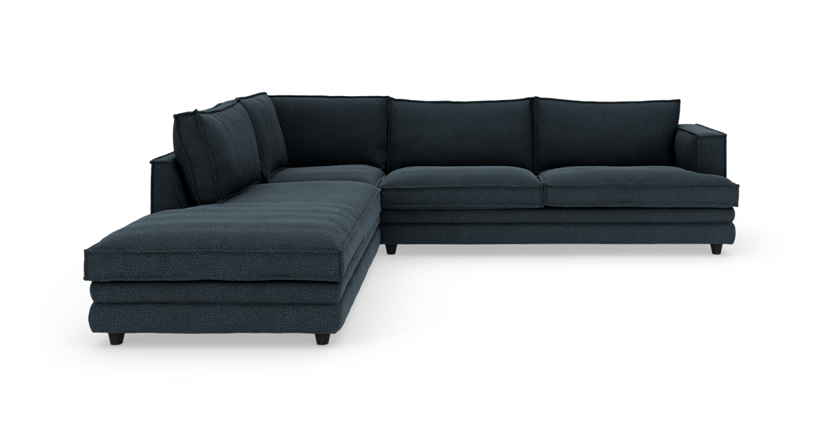 Mørkeblå L‑formet modulsofa med venstrevendt chaiselong, frilagt på hvid baggrund.