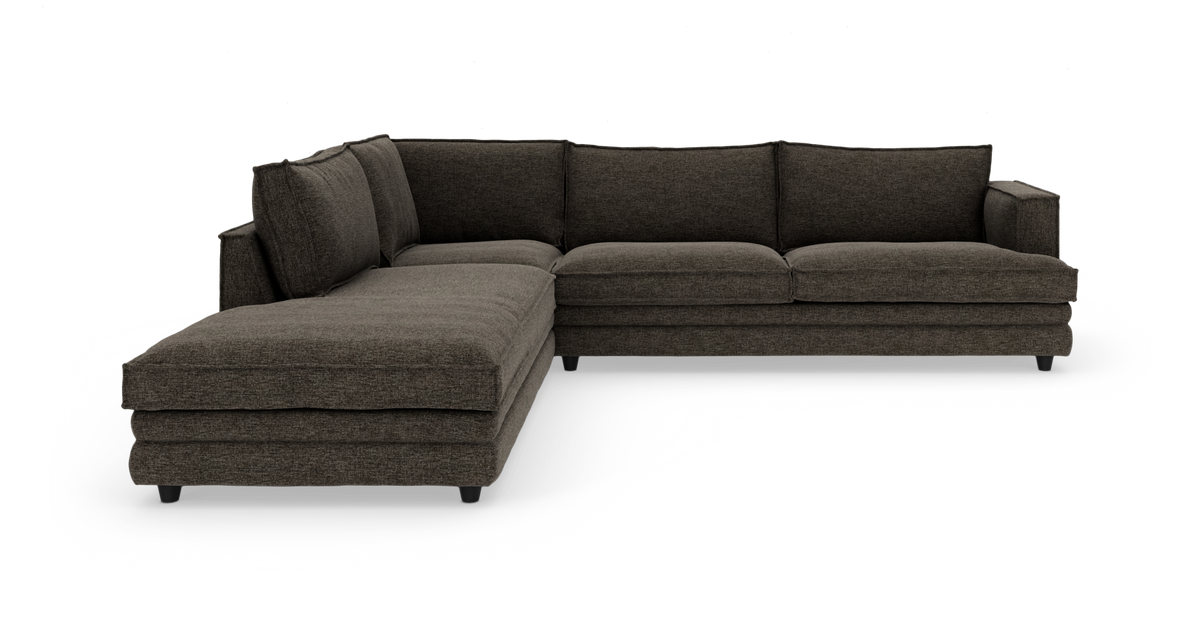 Mørkegrå L-formet modulsofa med chaiselong, fritstående på hvid baggrund.
