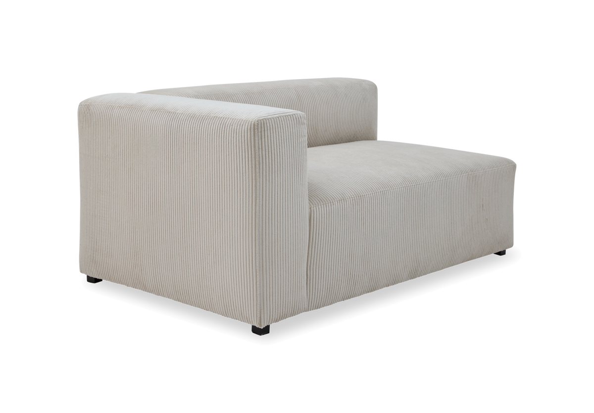 Beige modulsofa i cordfløjl med venstre armlæn, frilagt.