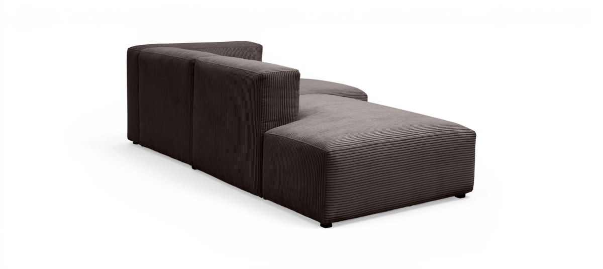 Modulsofa/chaise i mørkegrå fløjl med ribbet struktur, højrevendt chaiselong set bagfra i studiemiljø.