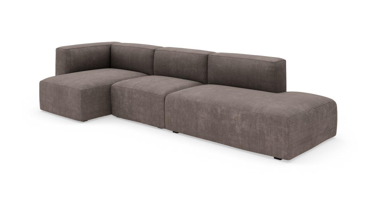 Modul-hjørnesofa i brungrå corduroy med lave rygge og bløde blokmoduler, frilagt på hvid baggrund.