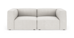 Lys beige modulsofa med brede armlæn, fritstående på hvid baggrund.