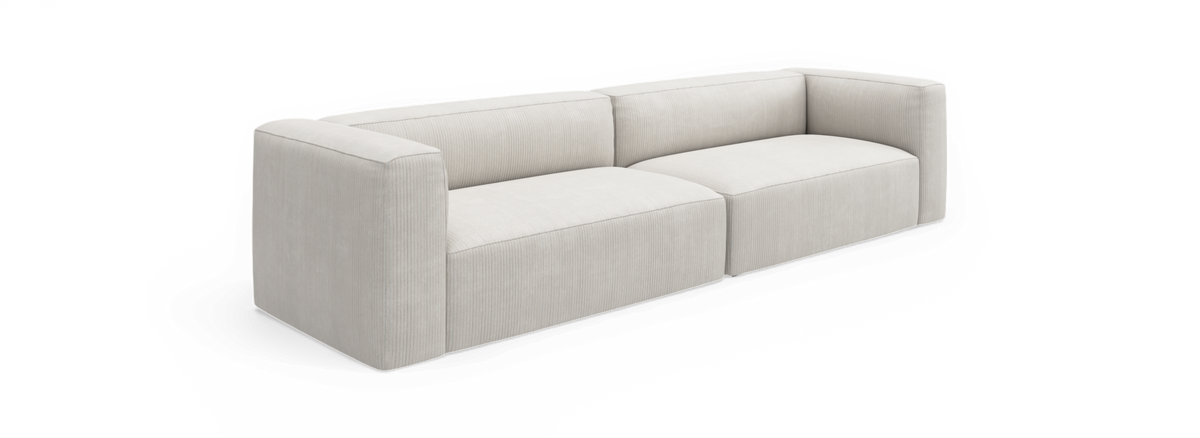 Lys beige moderne modulsofa med lave afrundede armlæn og ribbet betræk, vist forfra i vinkel på sort baggrund.