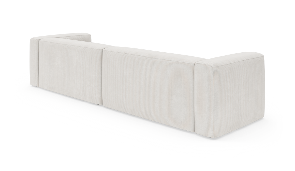 Modulsofa i lys beige stof set bagfra i vinkel, frilagt på hvid baggrund.