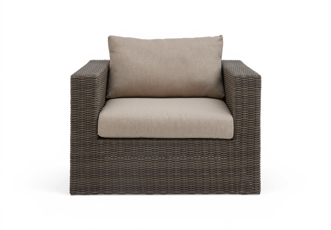 Brun rattan lænestol med beige hynder, frontvisning.