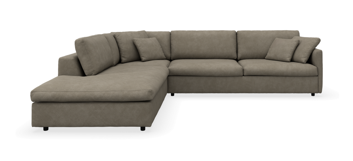 L-formet modulsofa i beige/gråt stof med chaiselong til venstre og løse puder, frilagt på hvid baggrund.