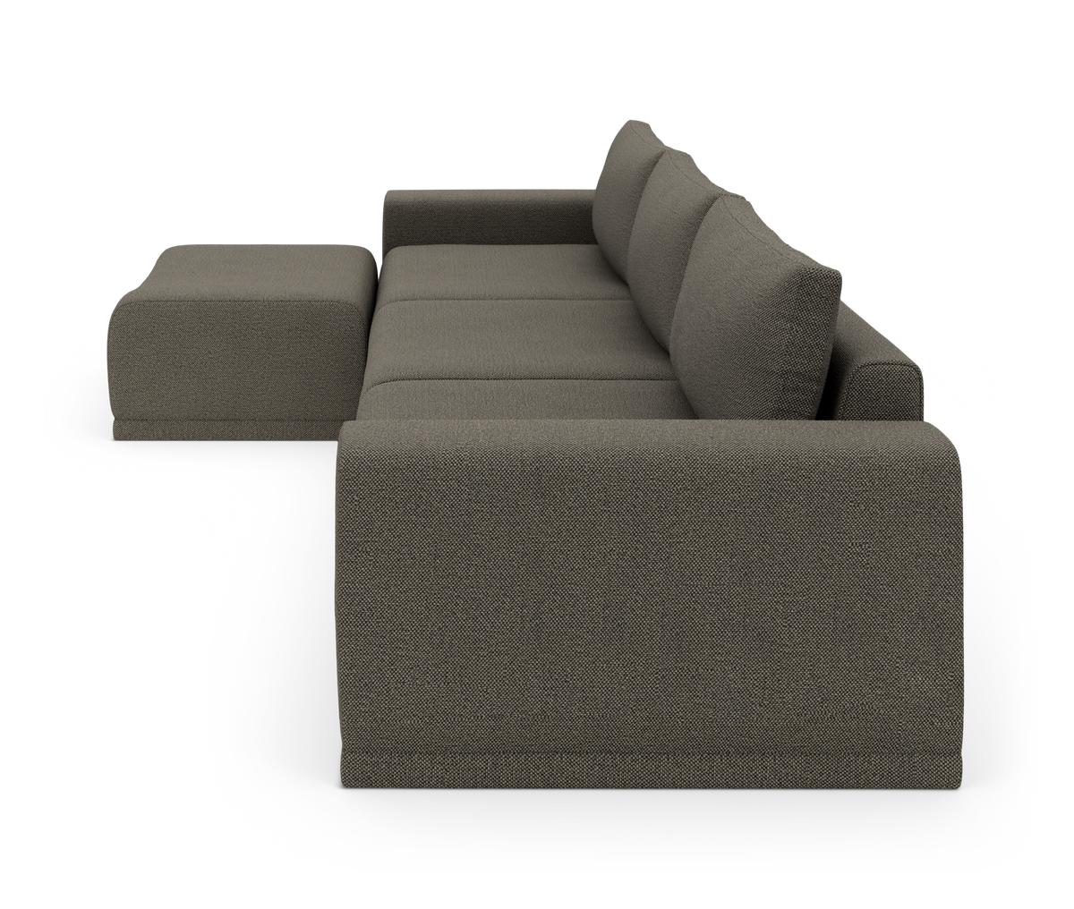 Modulsofa i mørkegråt stof med chaiselong/ottoman, set fra siden mod hvid baggrund.