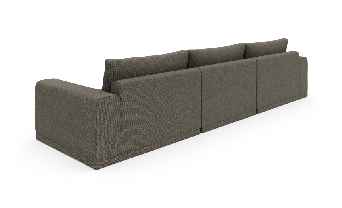 Bagfra set, modulær firesæders sofa i mørk taupegråt stof på hvid baggrund.
