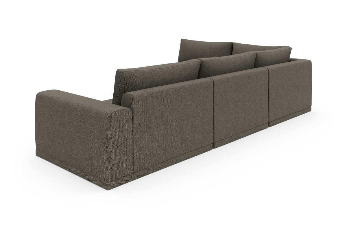 Modulsofa i mørkegråt stof set skråt bagfra, fritstående på hvid baggrund med fire ryghynder.