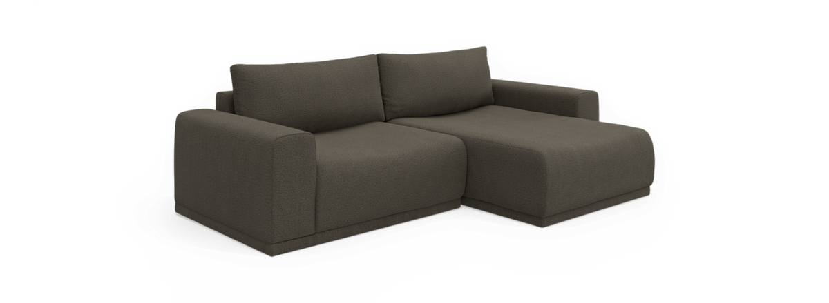 Mørkegrå modulsofa med chaiselong på højre side og to ryghynder, frilagt mod sort baggrund.