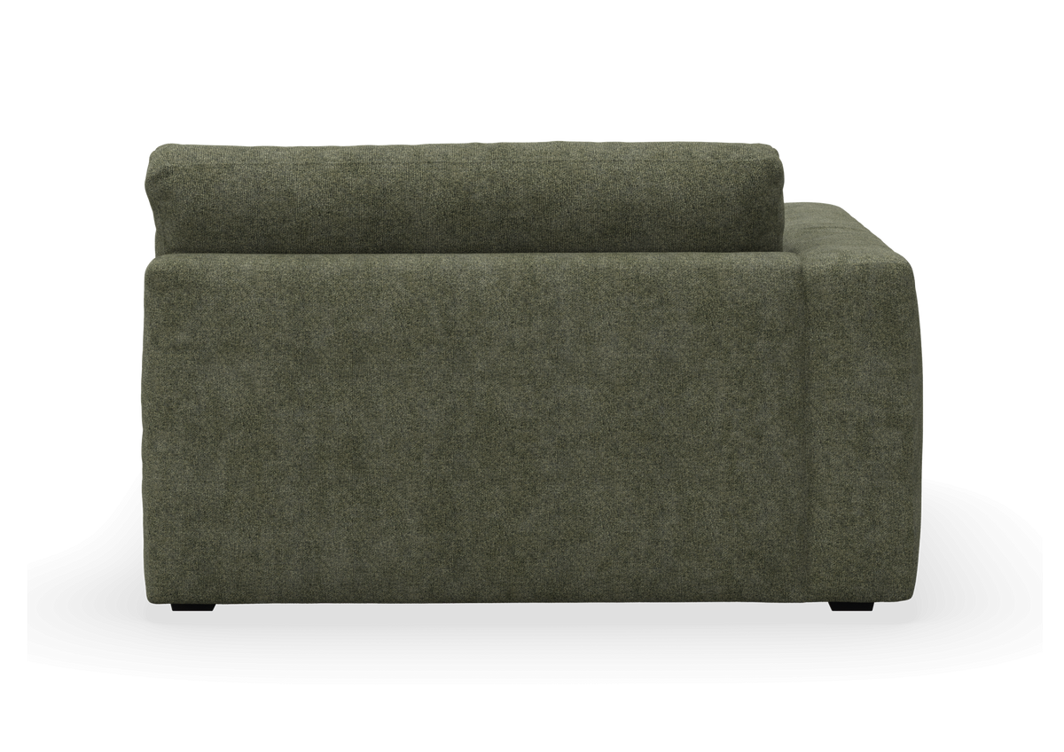 Grøn modulsofa set fra siden, fritlagt på hvid baggrund.