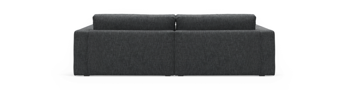 Mørkegrå sofa set bagfra mod sort baggrund.