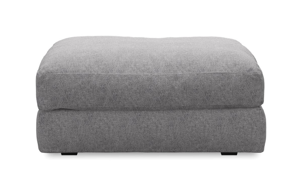 Grå stofbetrukket puff/ottoman, frontvisning, frilagt.