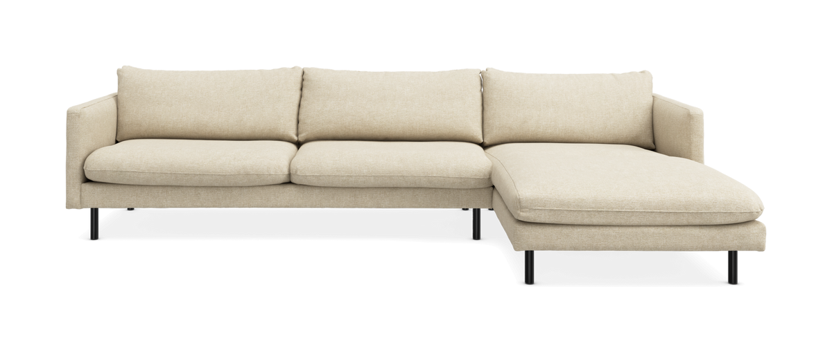 Beige hjørnesofa med chaiselong til højre, slanke sorte ben og minimalistisk design.