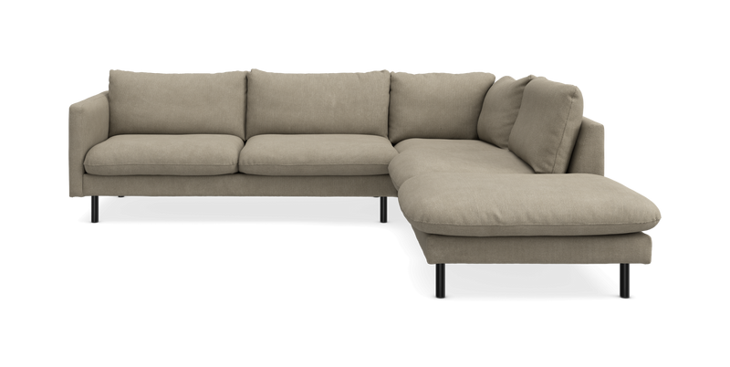 Beige hjørnesofa med chaiselong til højre, stofbetrukket med sorte ben, på hvid baggrund._ps