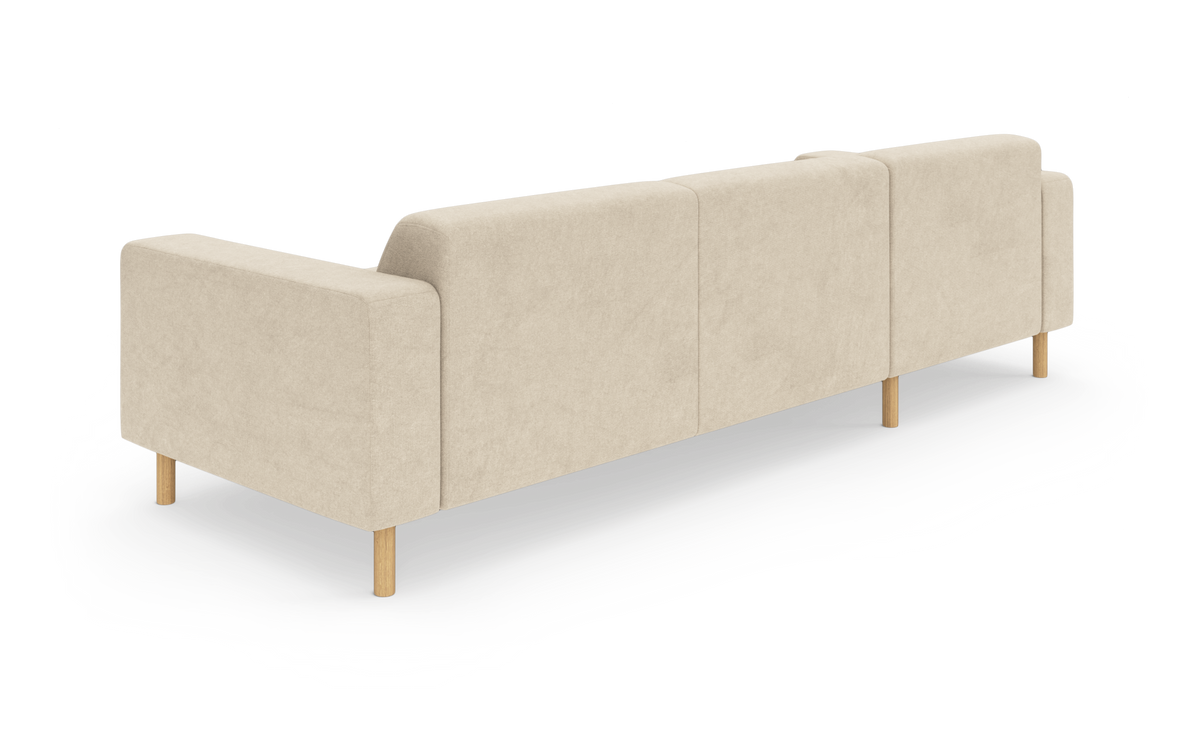 Beige modulsofa med træben set bagfra på hvid studiebaggrund.