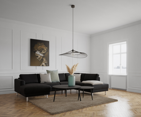 Lys skandinavisk stue med sort hjørnesofa, runde sorte sofaborde, turkis vase med pampasgræs på bordet, beige tæppe og sildebenstrægulv; hvid vægpanel, stort vindue og en slank sort pendellampe over, vægkunst til venstre.