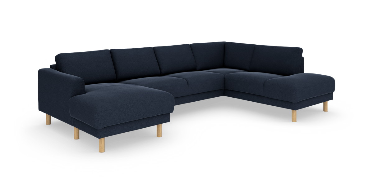 Mørkeblå modulær hjørnesofa med chaiselong og lyse træben på hvid baggrund.