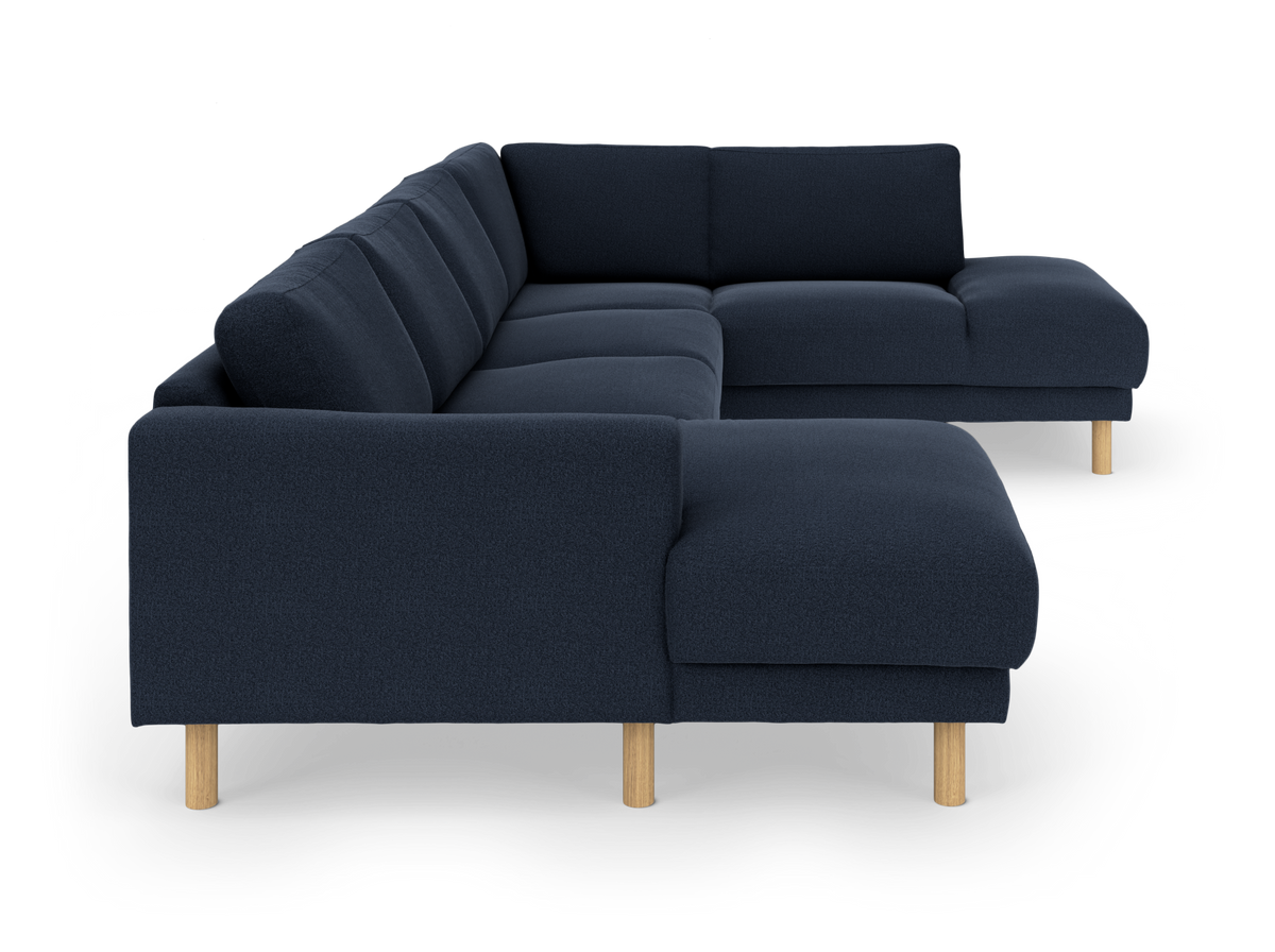 Mørkeblå hjørnesofa med træben.