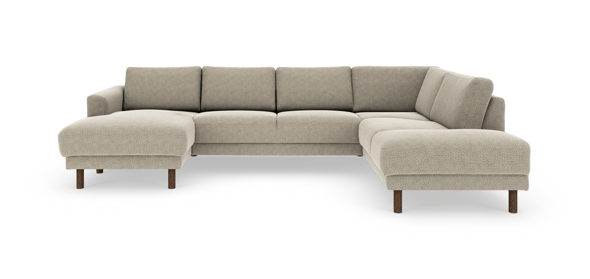L‑formet beige modulsofa med chaiselong til venstre og runde træben, frilagt på hvid baggrund.