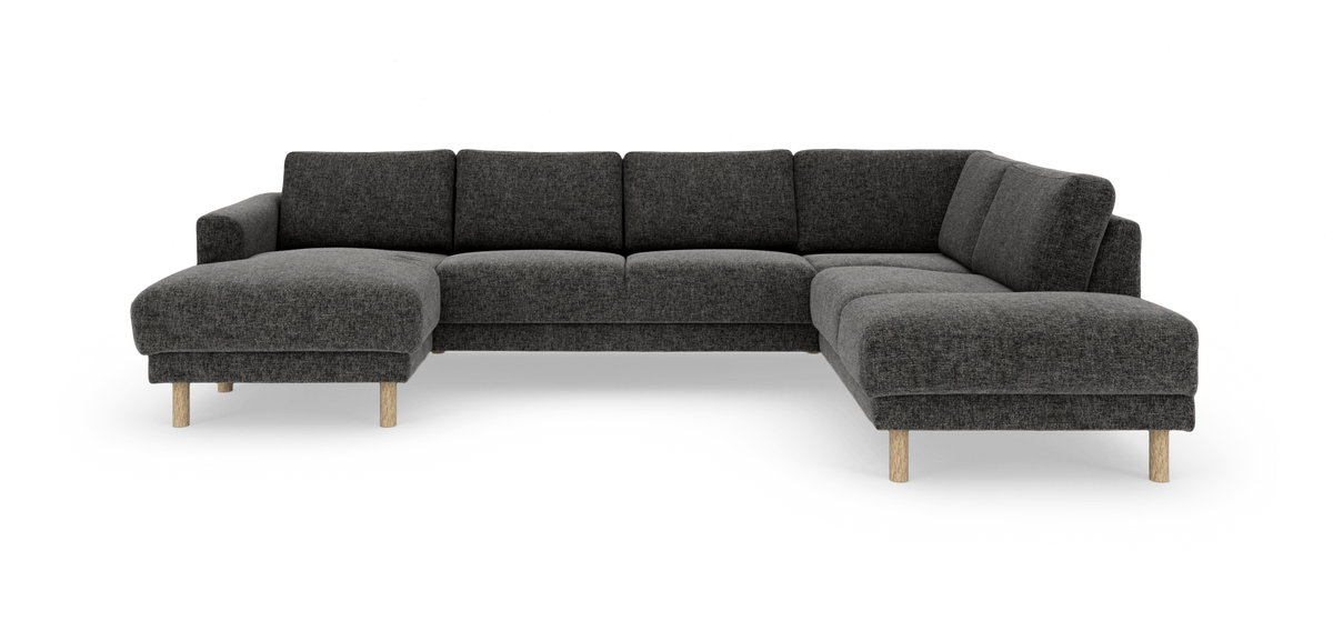 Mørkegrå U‑formet modulsofa med chaiselong og runde træben, frilagt på hvid baggrund.
