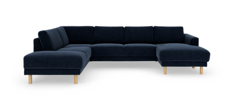 Stor mørkeblå hjørnesofa med chaiselong til højre og lyse træben, frilagt på hvid baggrund.