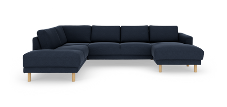 Mørkeblå hjørnesofa med chaiselong og lyse træben, frilagt på hvid baggrund.