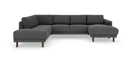 Mørkegrå L‑sofa med chaiselong til højre og runde træben, fritstående mod hvid baggrund.