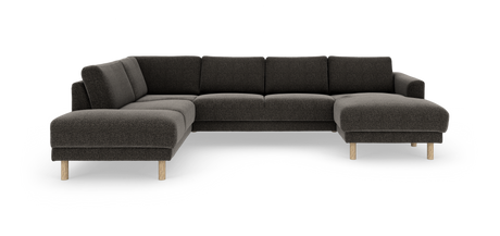 Mørkegrå L‑formet hjørnesofa med chaiselong til højre og lyse træben, frilagt mod hvid baggrund.