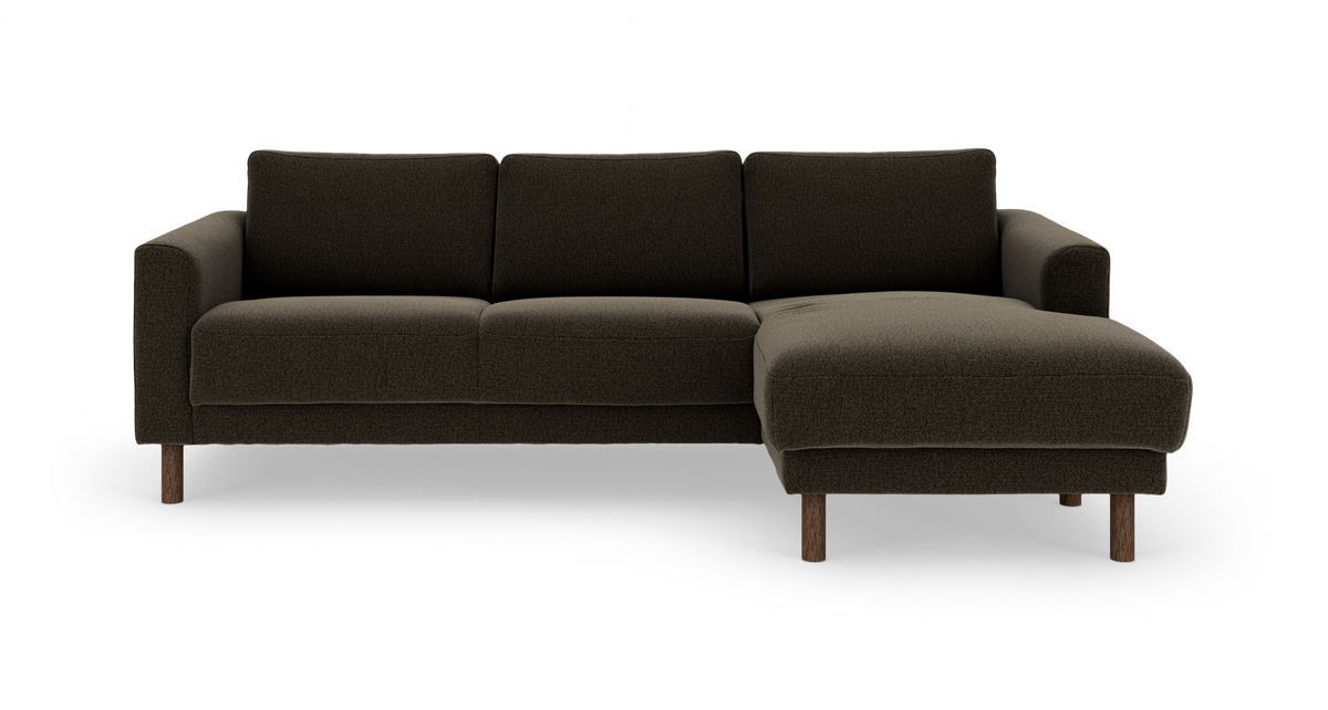 Mørkebrun 3-personers sofa med chaiselong til højre på træben, frontvisning, fritlagt på hvid baggrund.