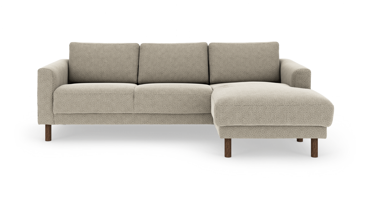 Beige hjørnesofa med chaiselong til højre og træben, fritlagt på hvid baggrund.