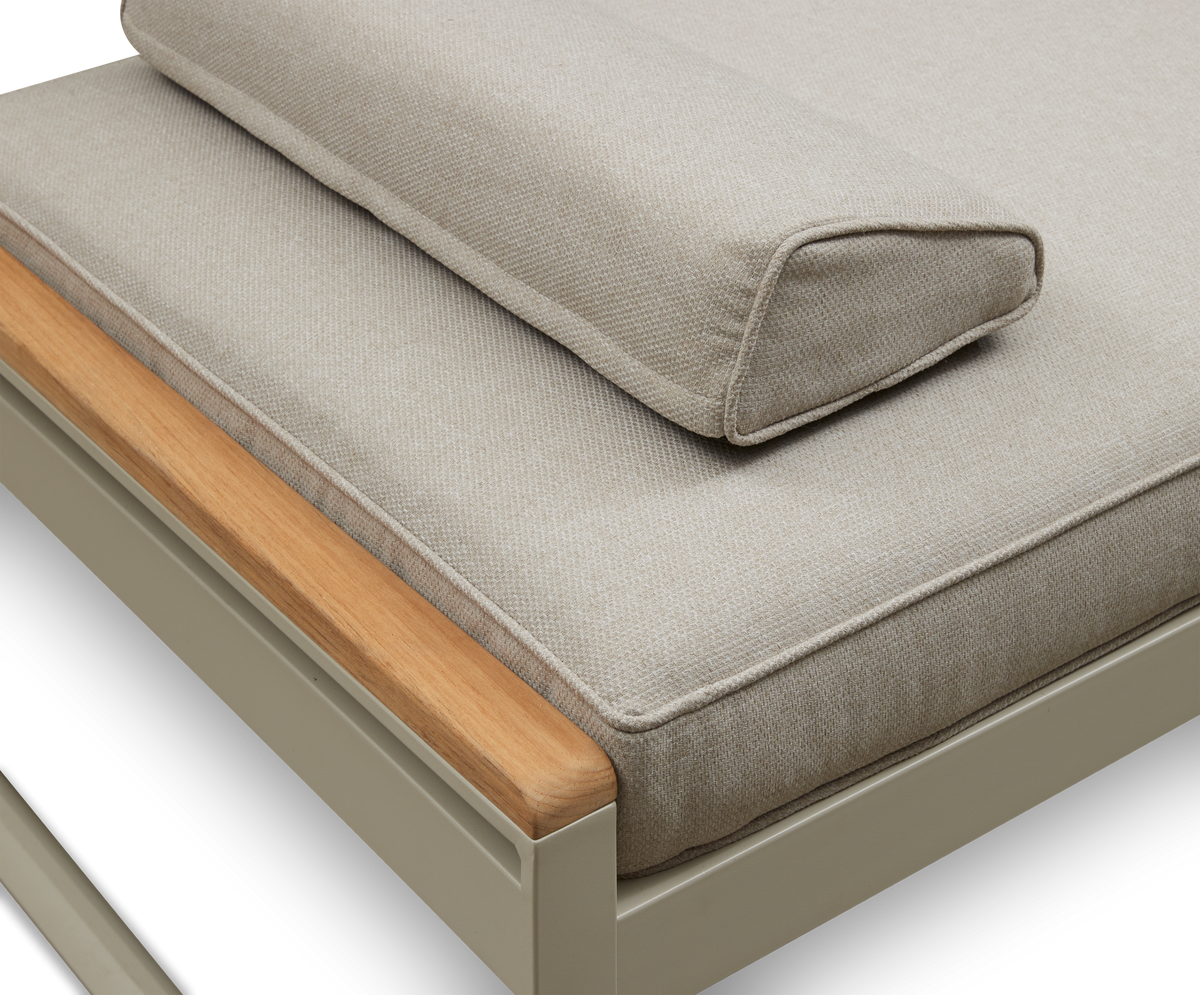 Detalje af beige hynder og kileformet nakkepude på bænk/sofa med lyst træ og pulverlakeret metalstel.