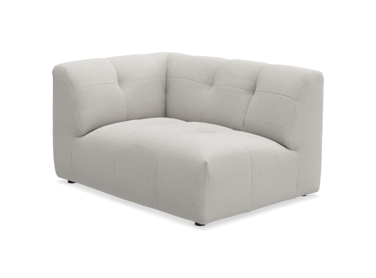 Lys beige modul-hjørnedel til sofa med blød, quiltet polstring.