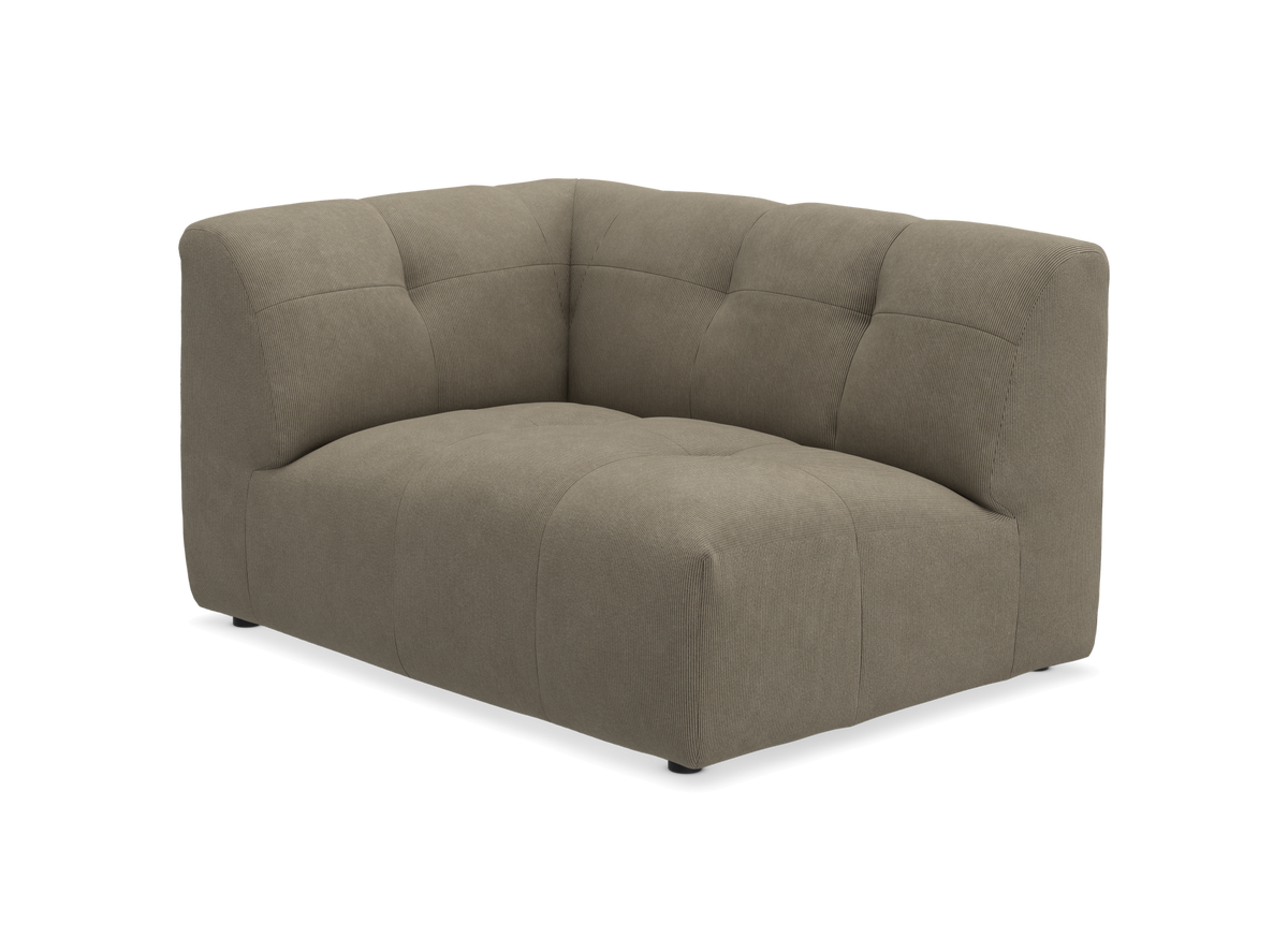 Beige hjørnemodul til sofa i stof med blød, vatteret/kviltet finish, set i vinkel på hvid baggrund.