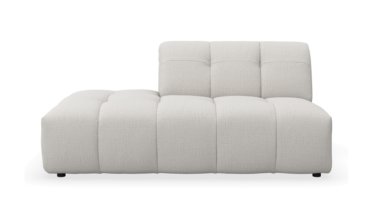 Lys beige modulsofa med venstrevendt chaiselong og polstret, kviltet sæde; fritlagt produktbillede.
