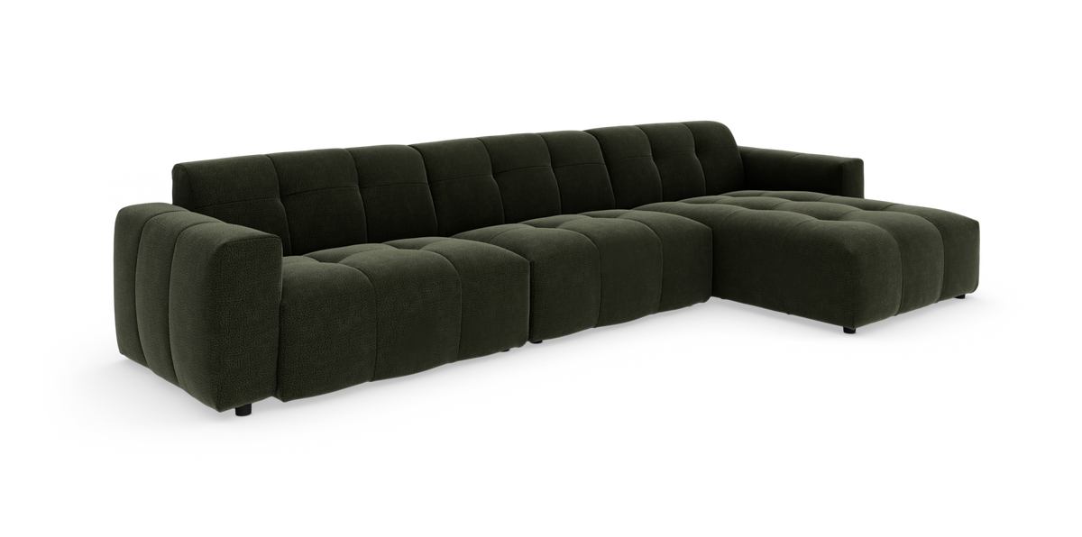 Mørkegrøn modulsofa med chaise longue og bløde, tuftede sektioner på hvid studiebaggrund.