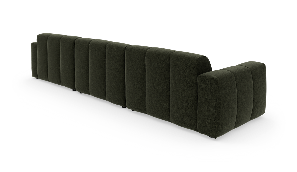 Mørkegrøn modulsofa set bagfra i studiemiljø.
