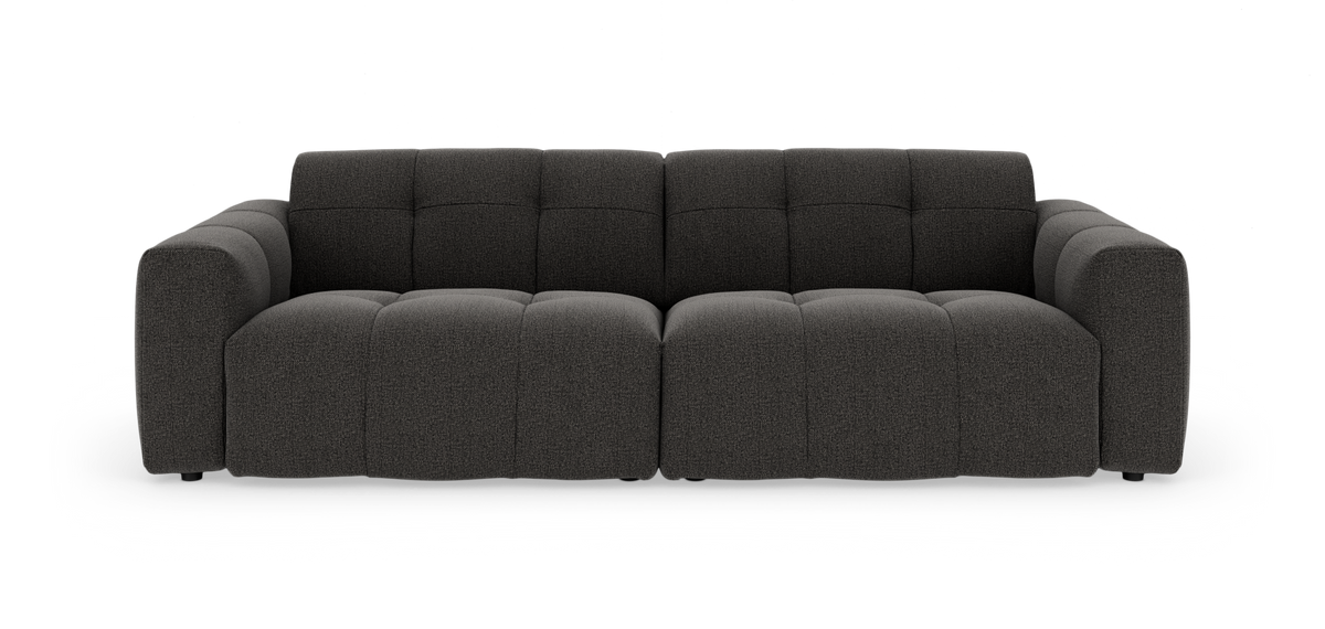 Mørkegrå modulsofa med brede armlæn, fotograferet lige forfra mod hvid studiobaggrund.